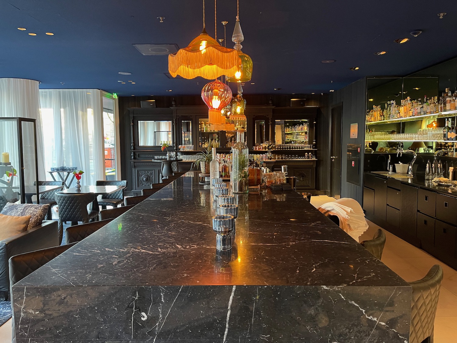 a bar with a black counter and a black ceiling