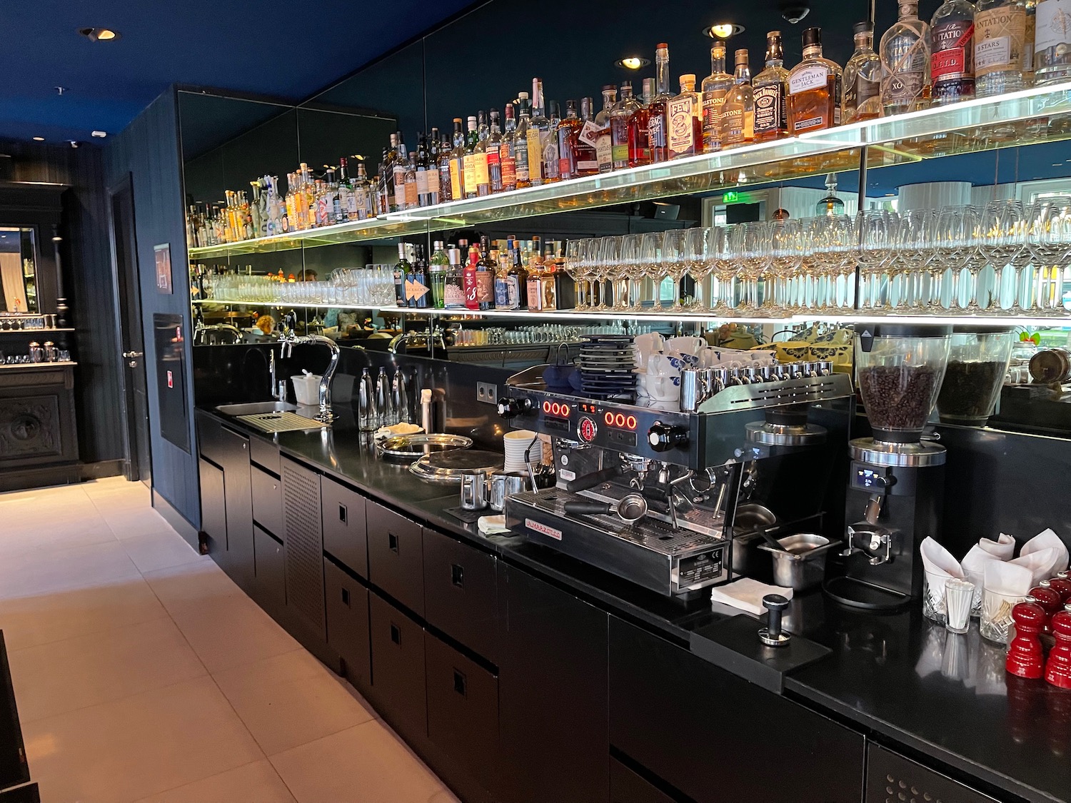 a bar with shelves of liquor and glasses