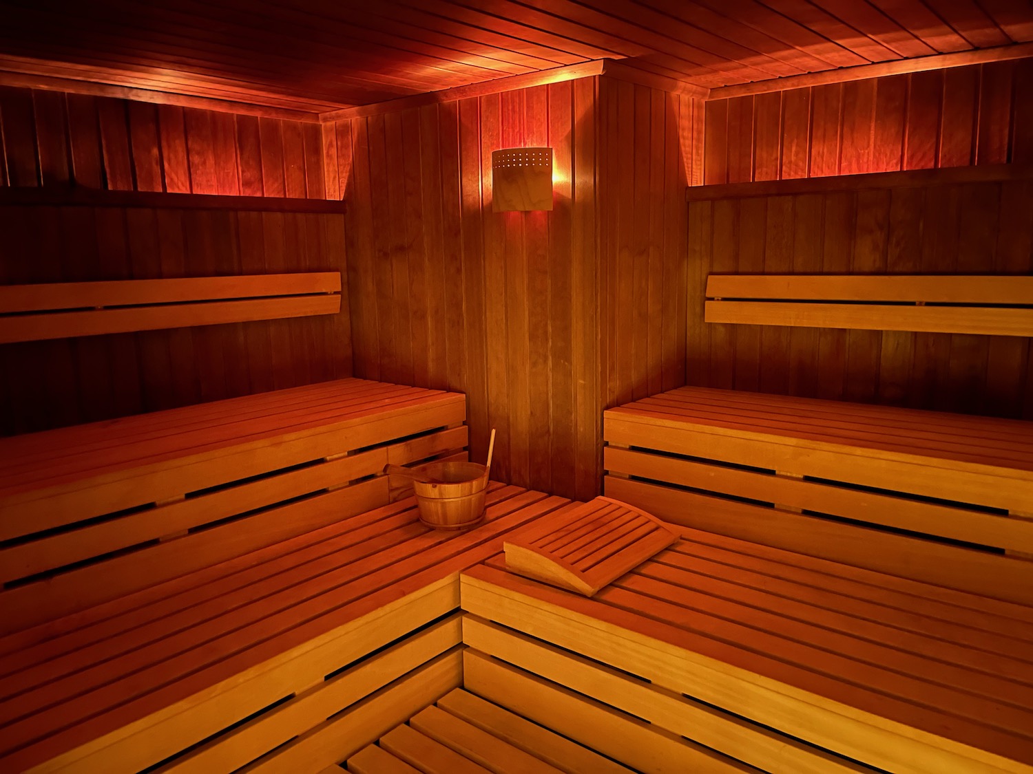 a wooden sauna with a bucket and bucket