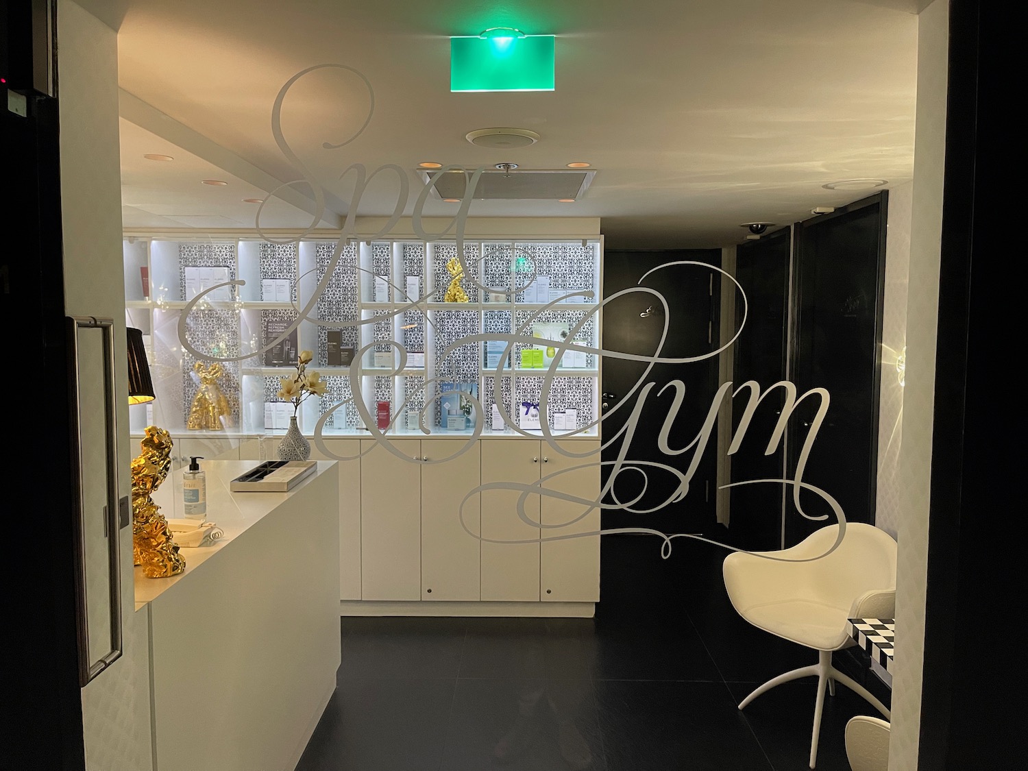 a white counter with a gold sculpture and a gold statue on it