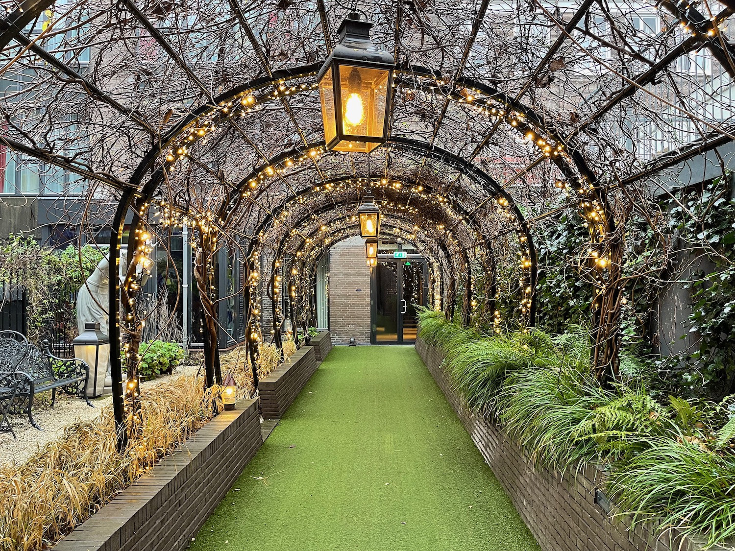 a walkway with lights and trees