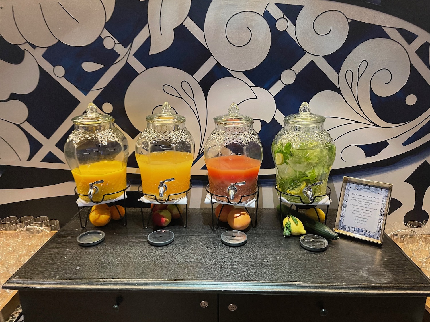 a group of juice dispensers on a table