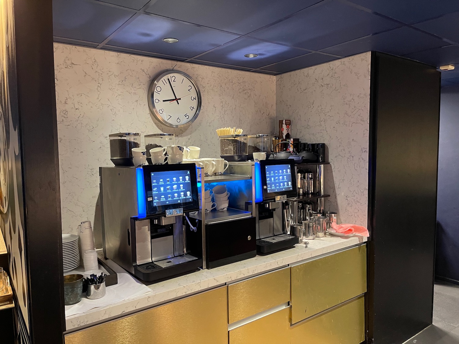 a coffee machine and a clock on a counter