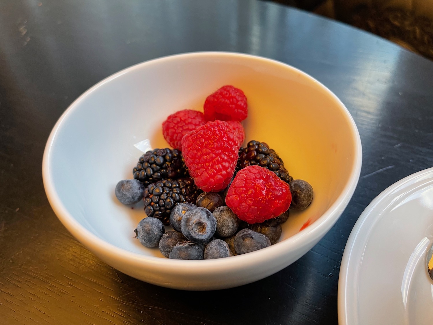 a bowl of berries on a table