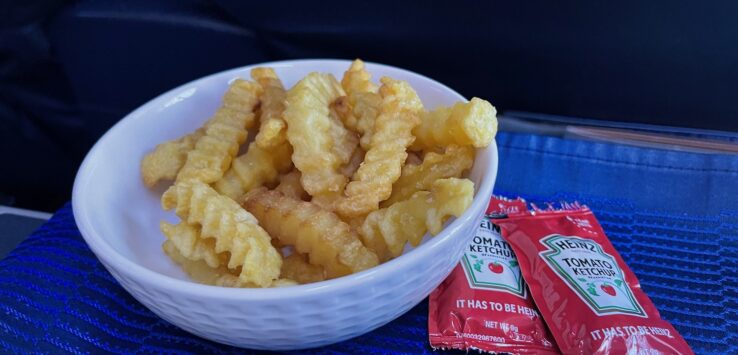 a bowl of french fries and ketchup