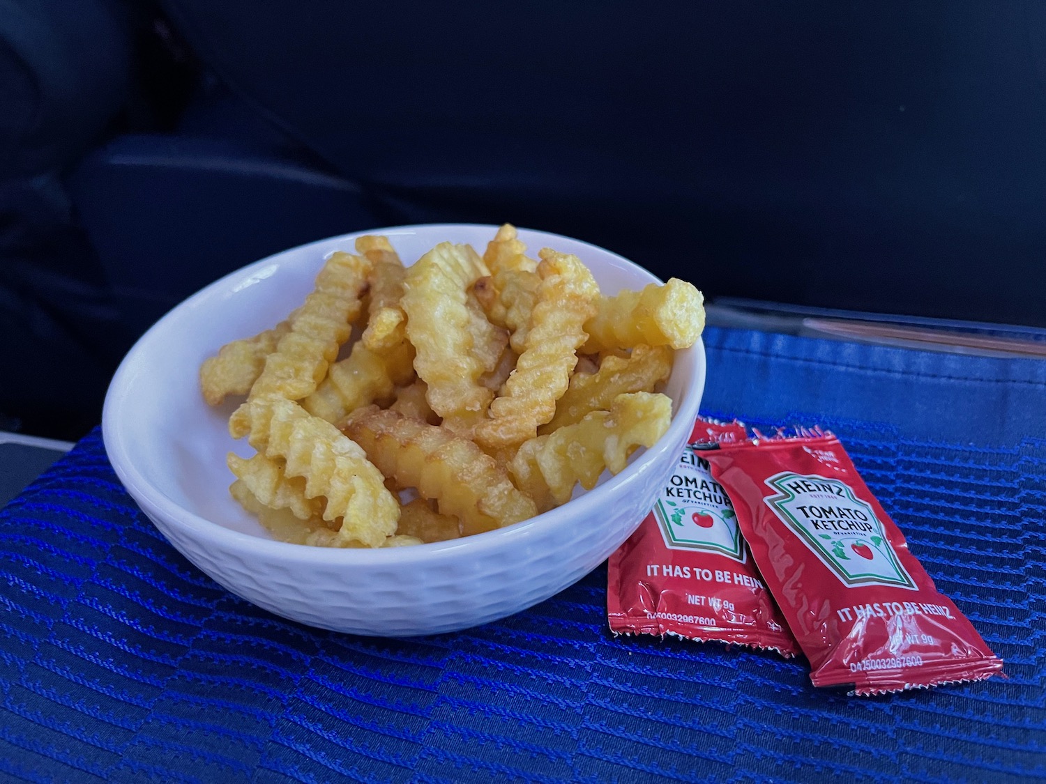 a bowl of french fries and ketchup