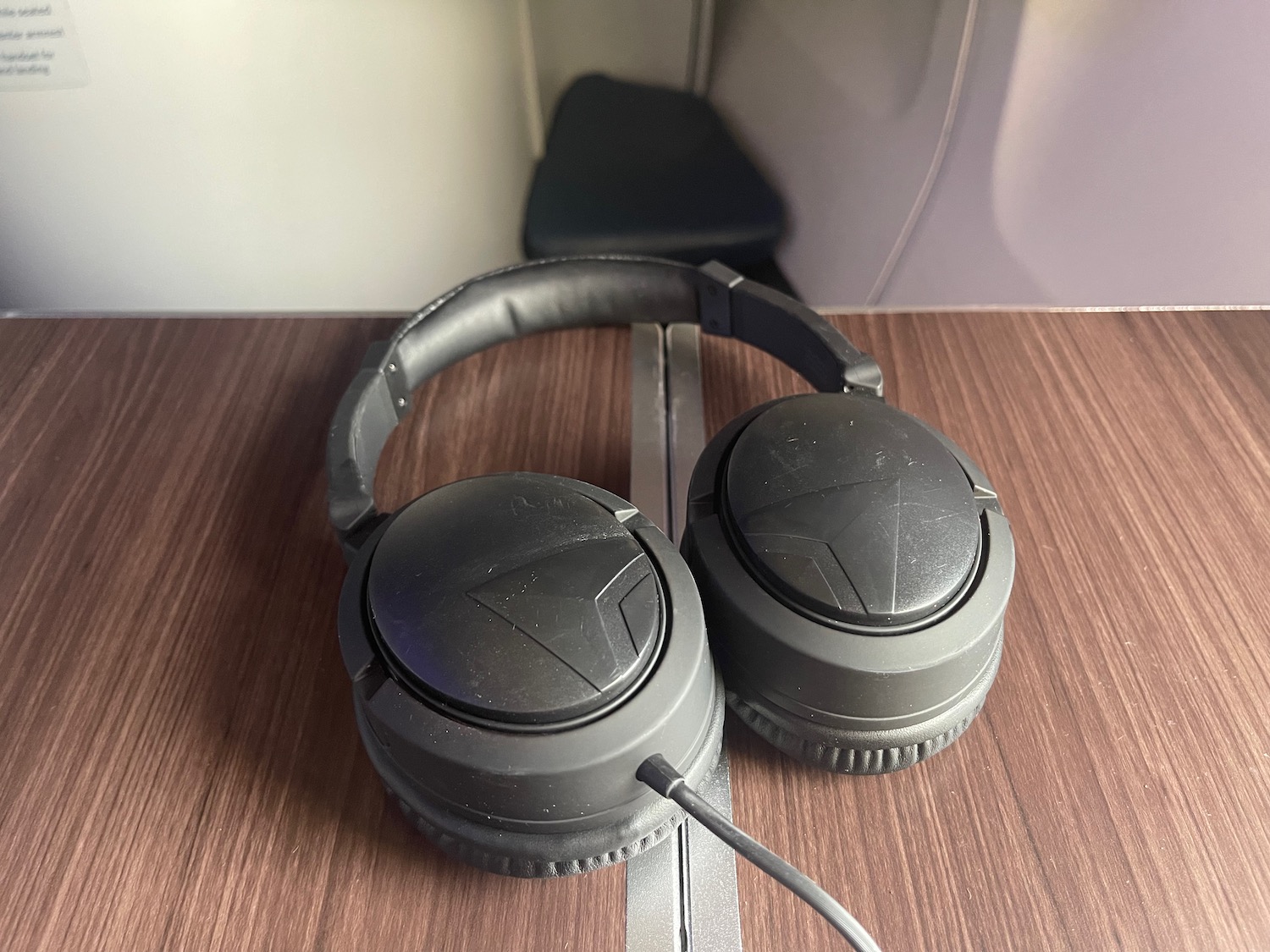 a pair of black headphones on a wood surface