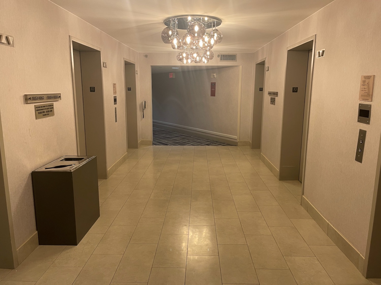 a hallway with a chandelier and doors