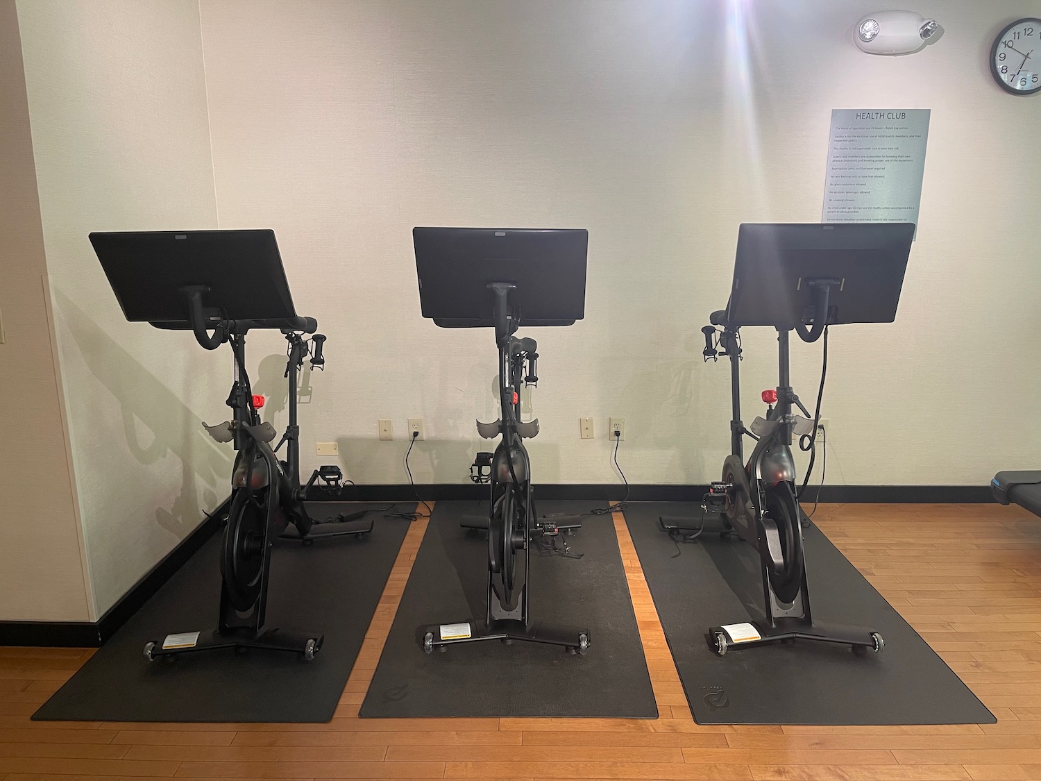 a group of exercise bikes on mats