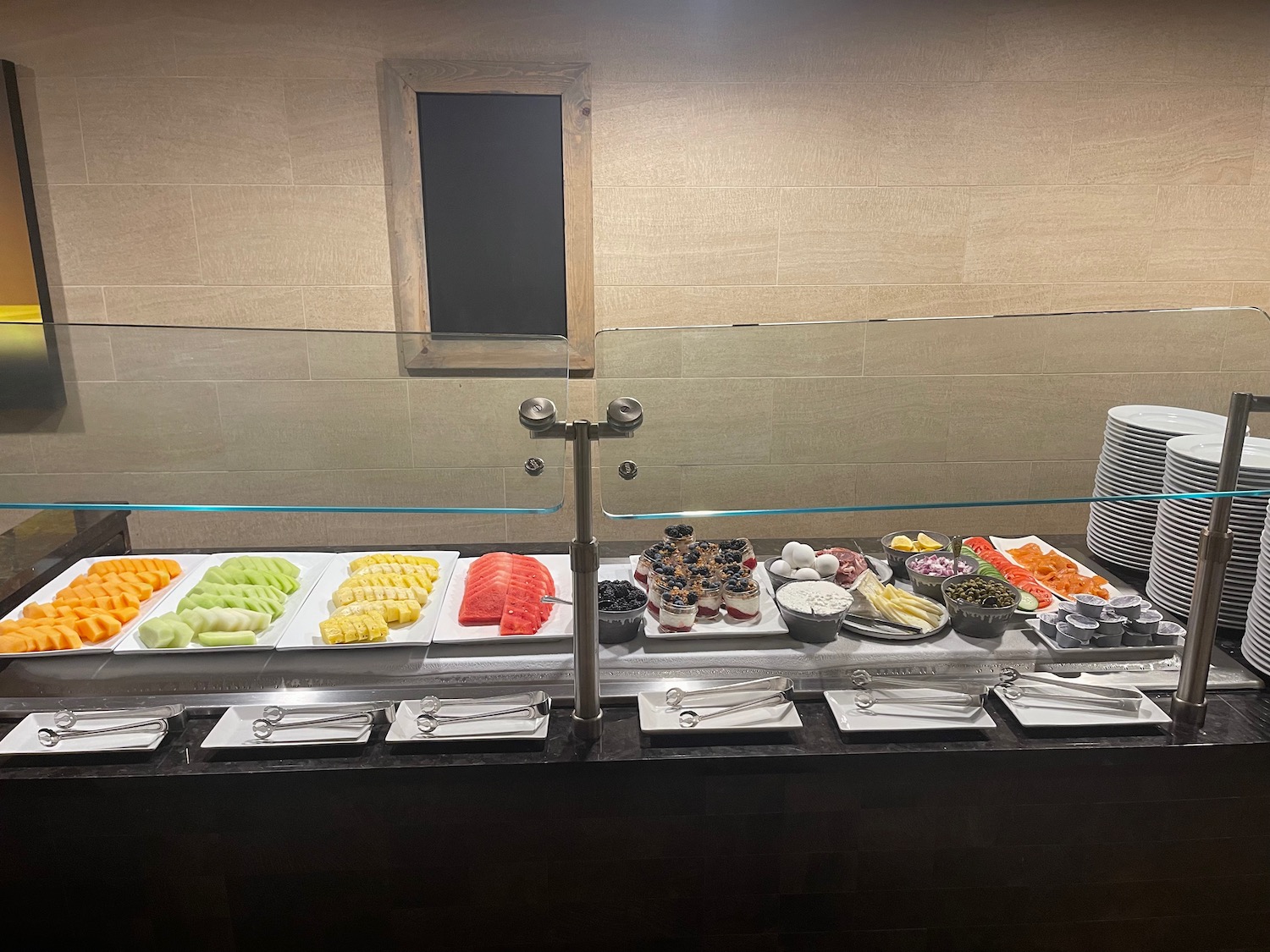 a buffet with different types of fruit on plates