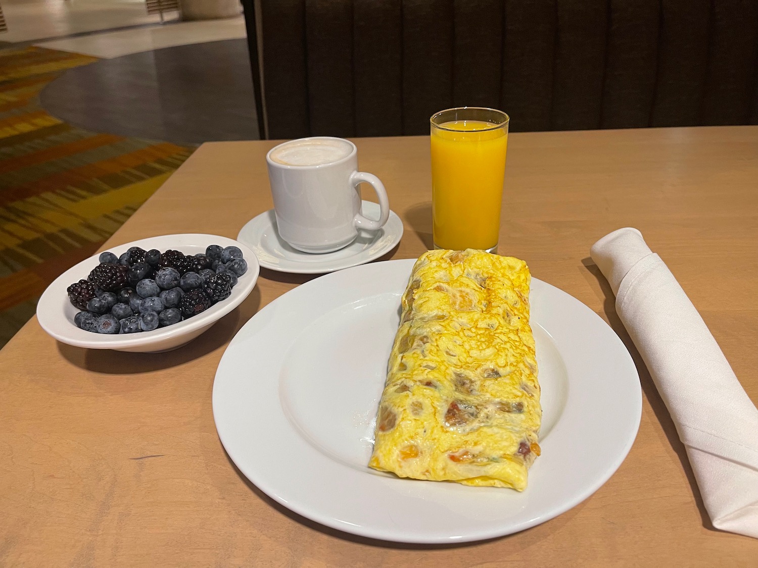 a plate of food and a glass of juice on a table