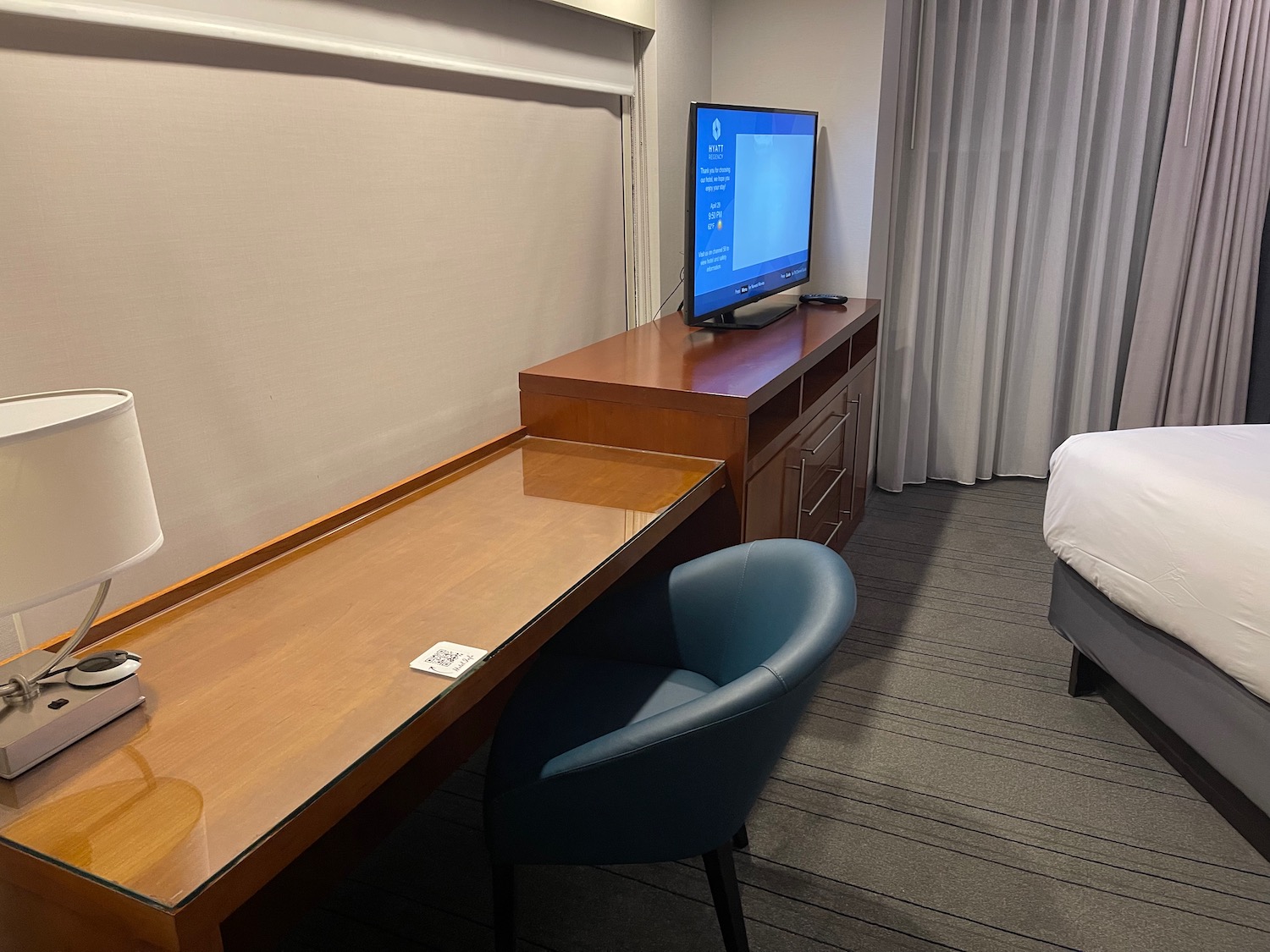 a desk and a tv in a hotel room