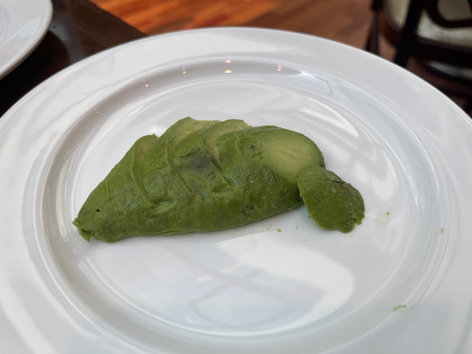 a green food on a white plate