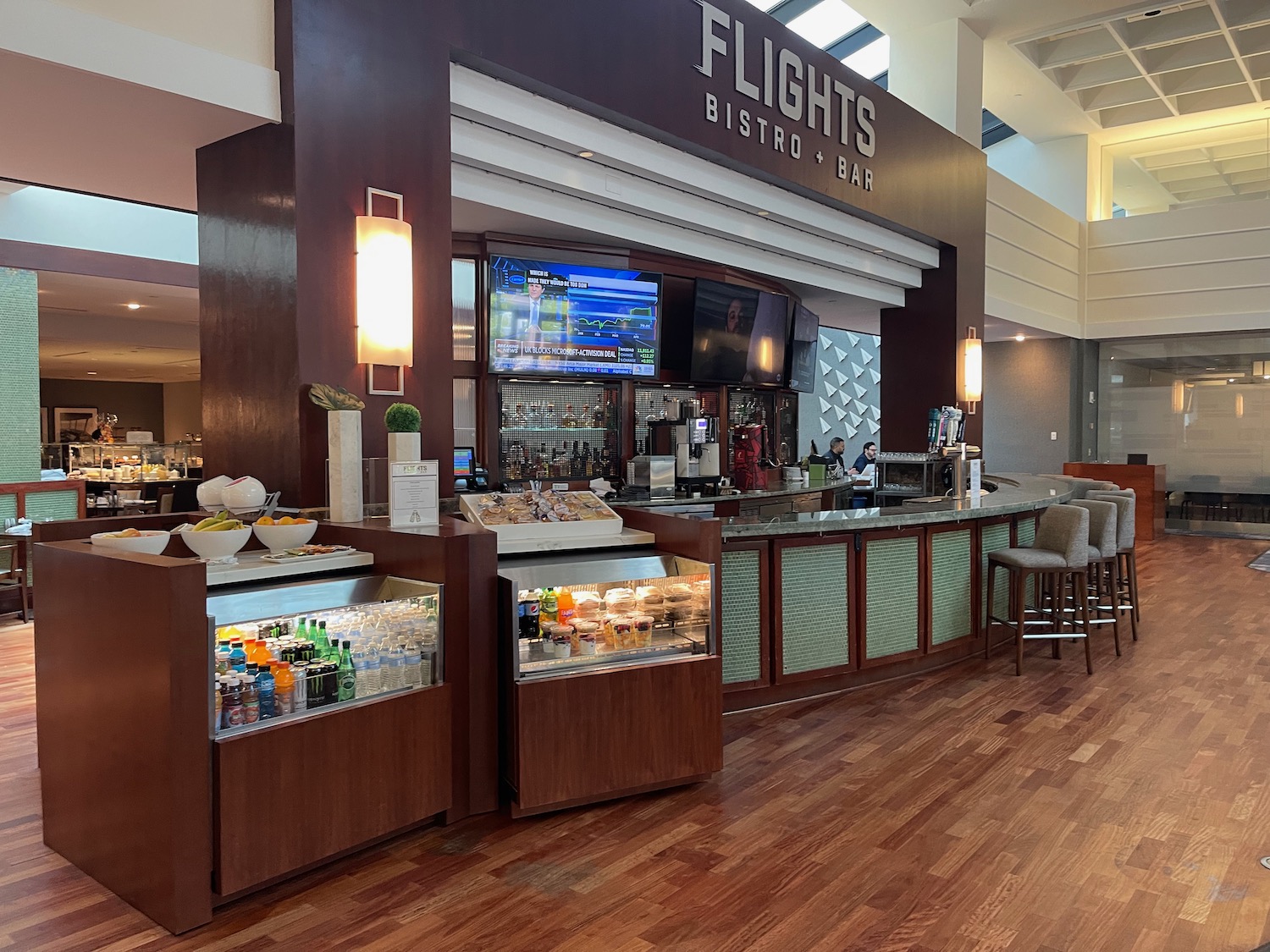 a bar with drinks and a counter in a building