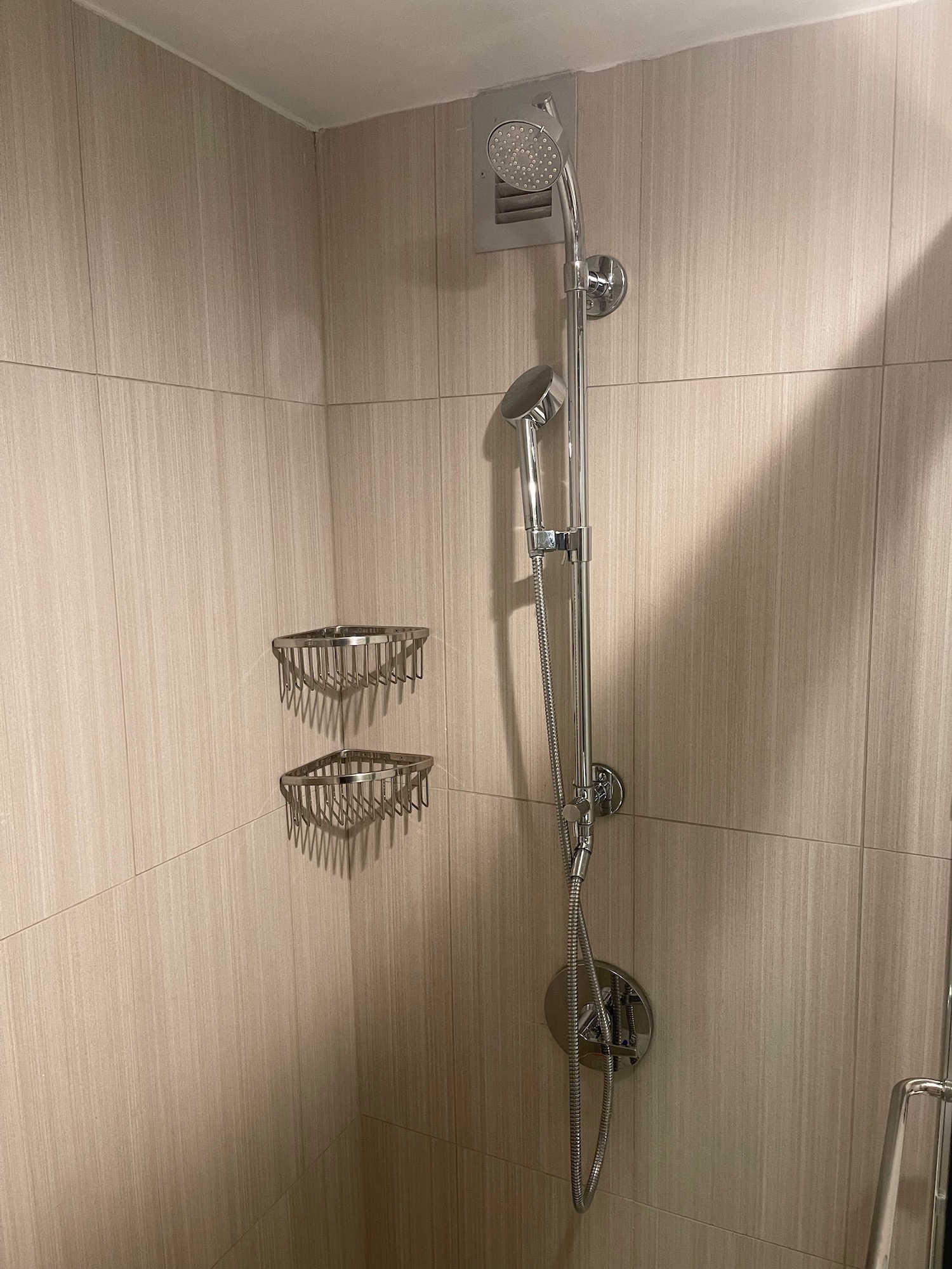 a shower with a shower head and a shower head