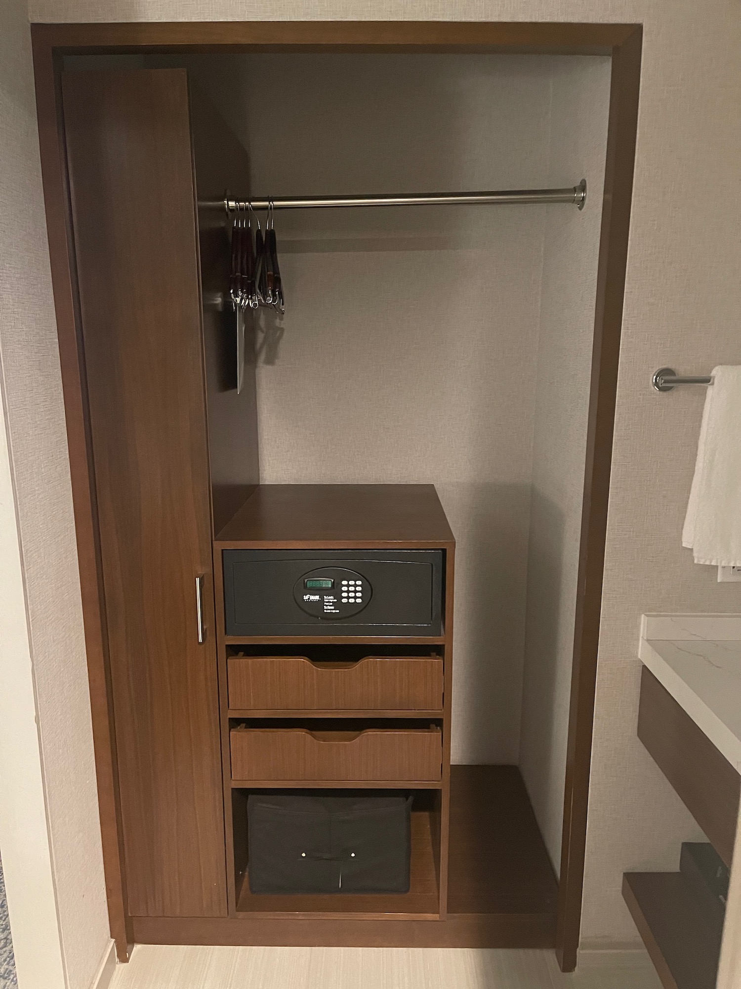 a closet with a safe and a rack
