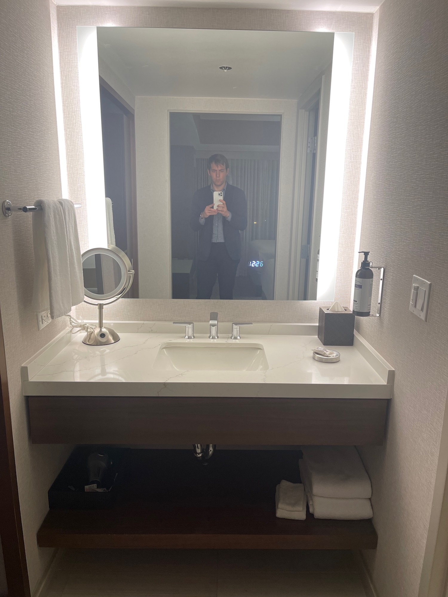 a man taking a selfie in a bathroom mirror