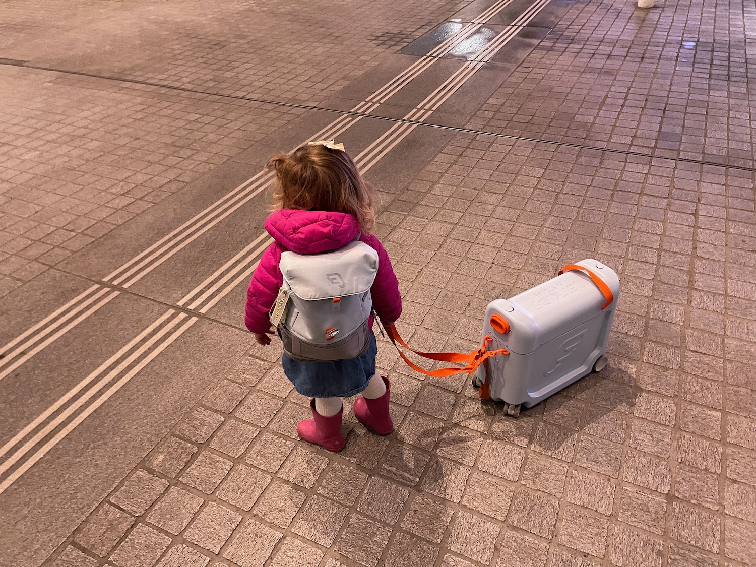 a child standing with a luggage case