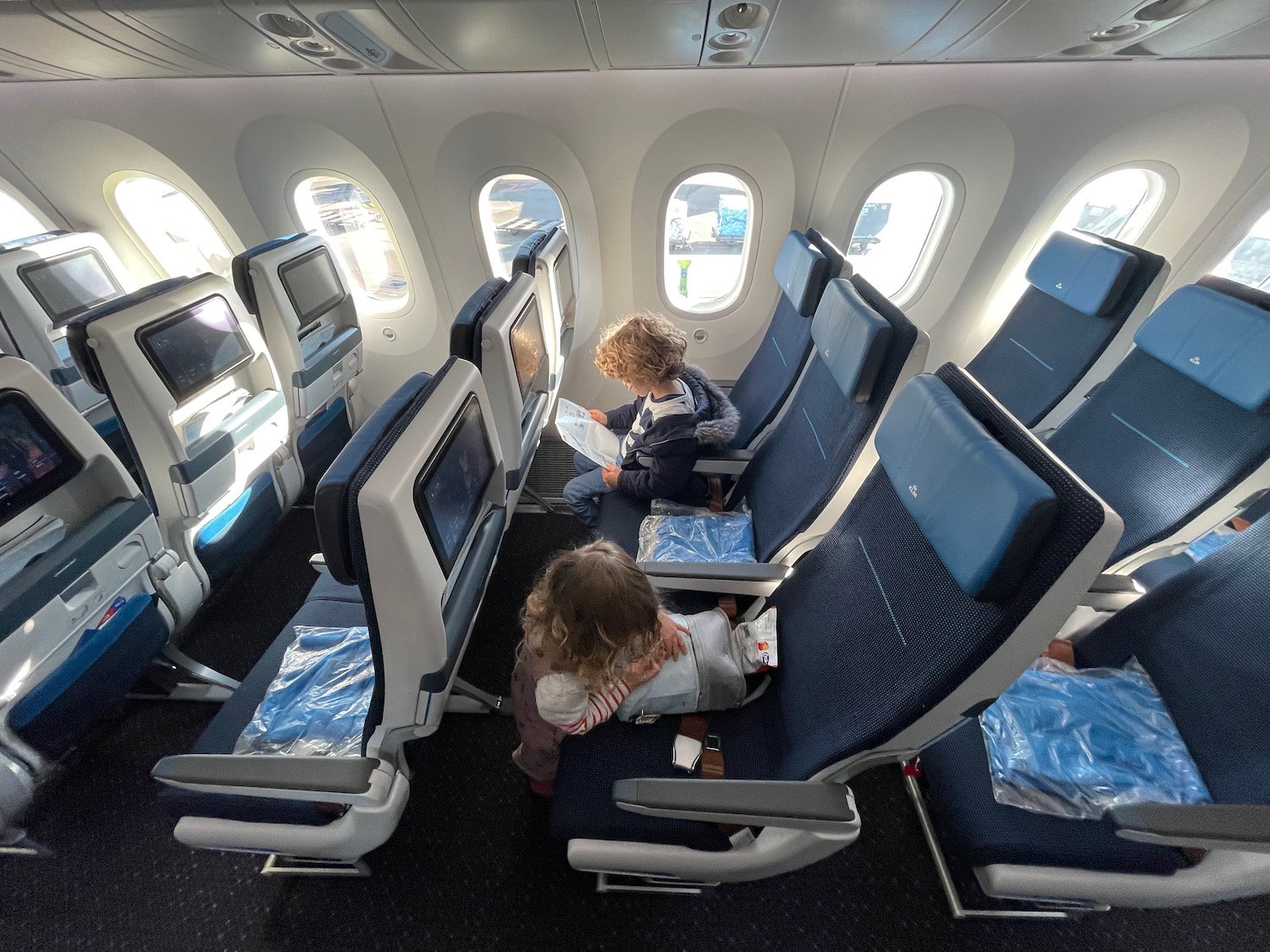 a group of kids sitting in an airplane