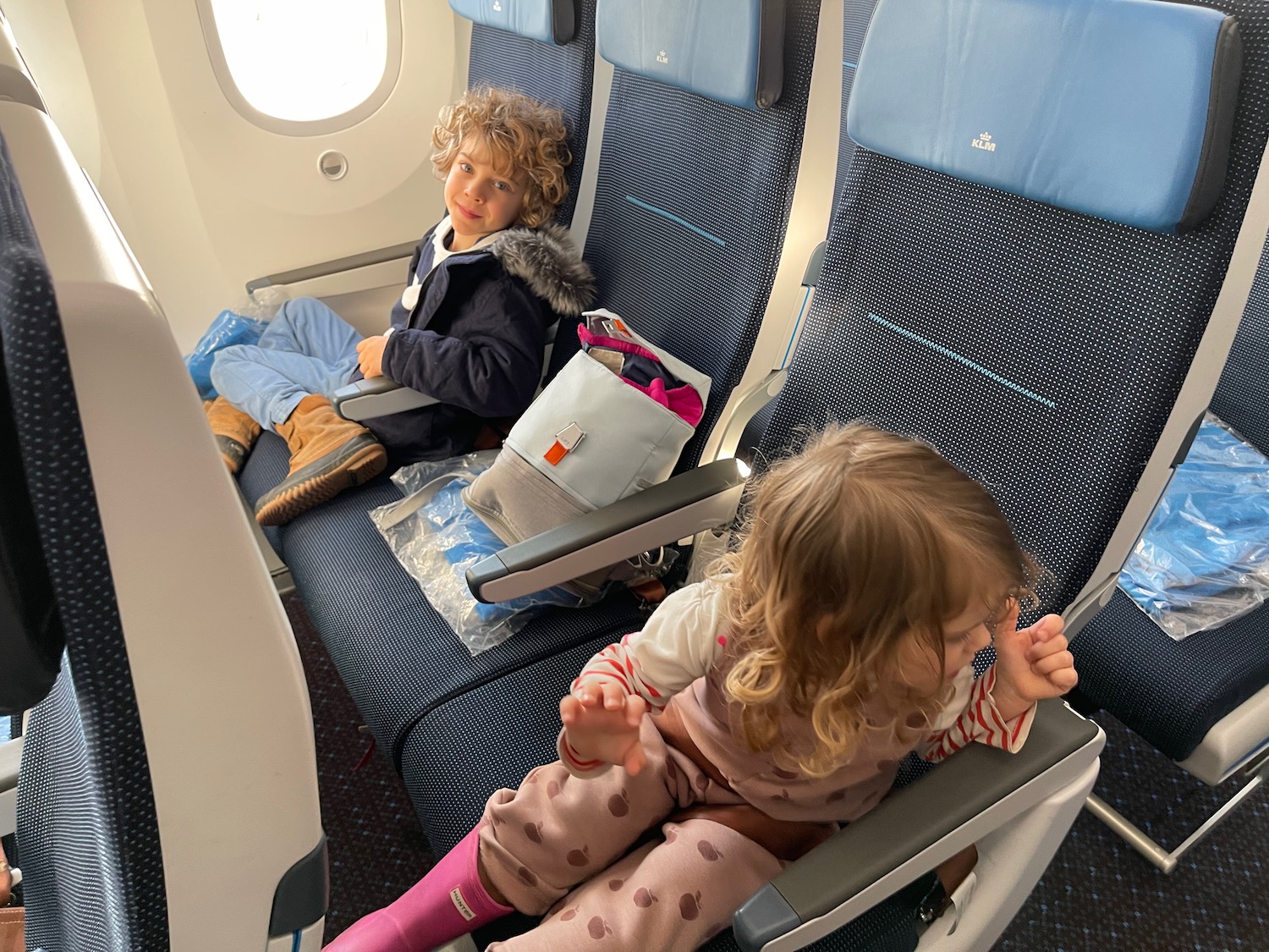 a boy and girl sitting in a plane