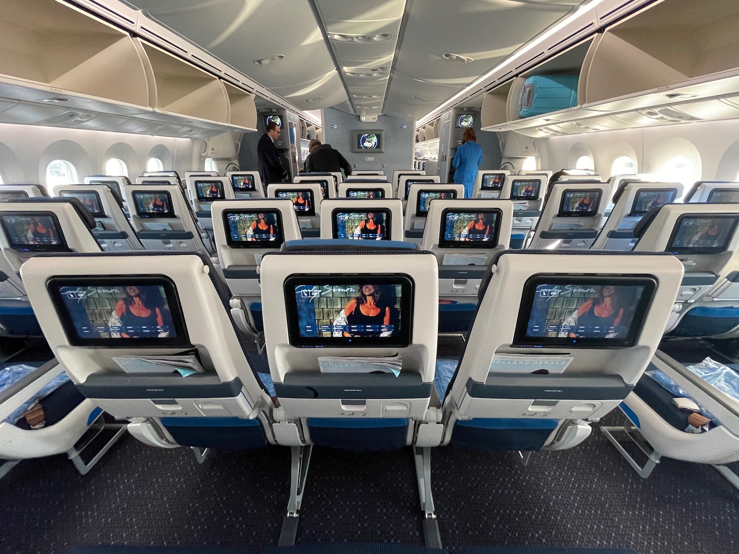 an airplane with rows of seats and monitors