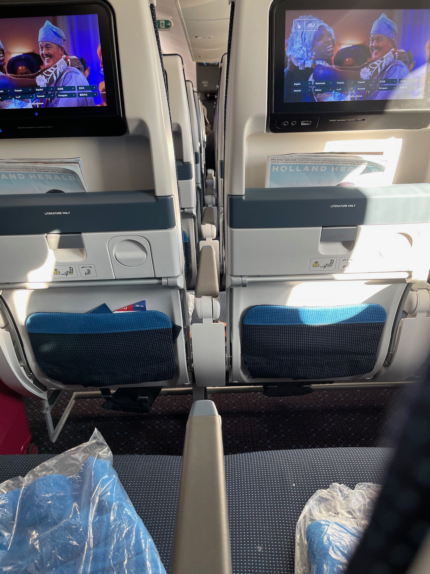a row of seats with a television on the side