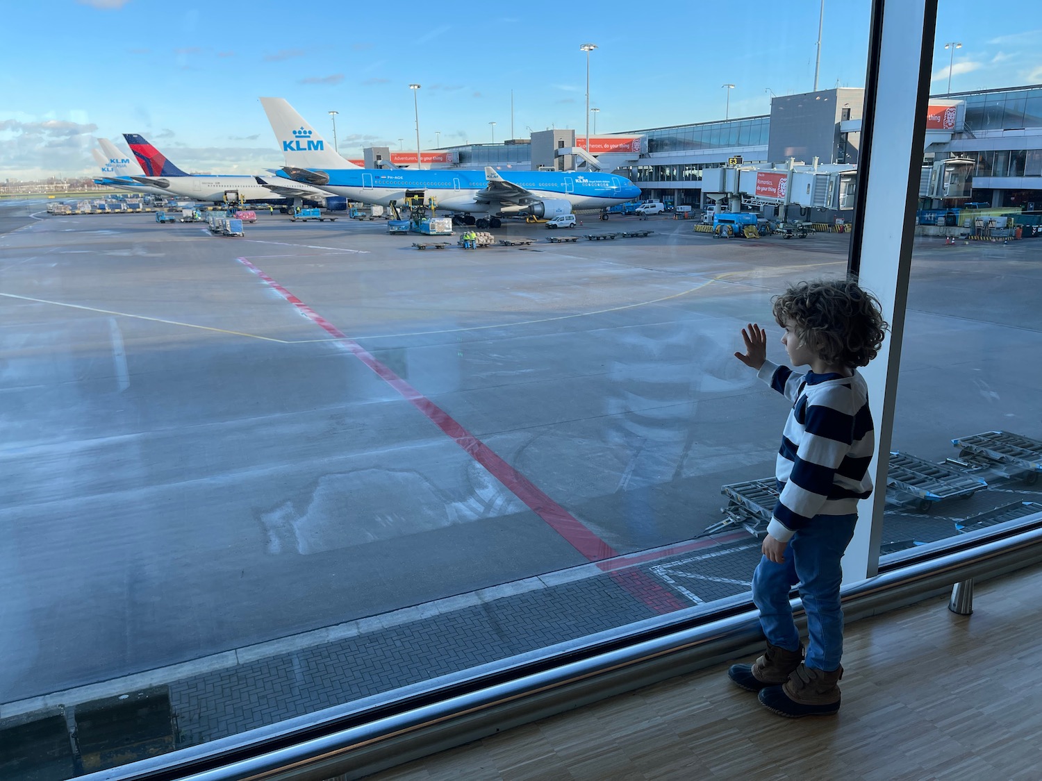 a child looking out a window at airplanes
