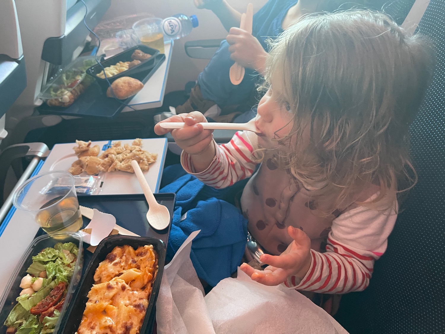 a child eating food on an airplane