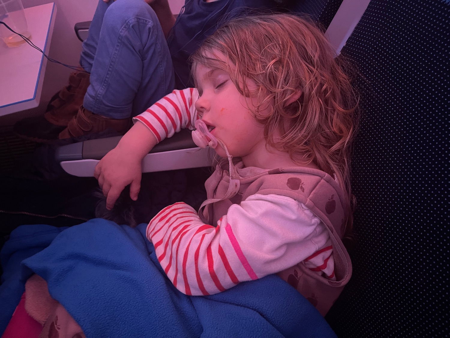 a child sleeping on a plane