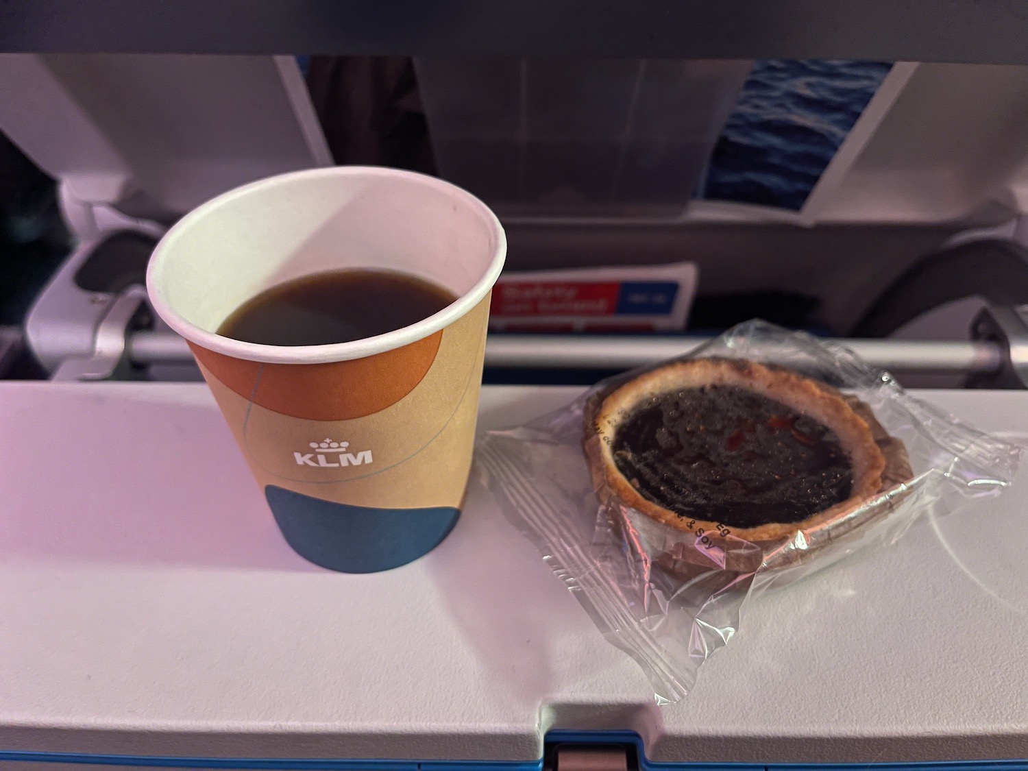 a cup of coffee and a pie on a tray