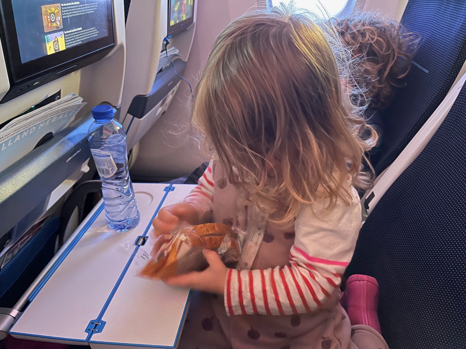 a child sitting on a chair in an airplane