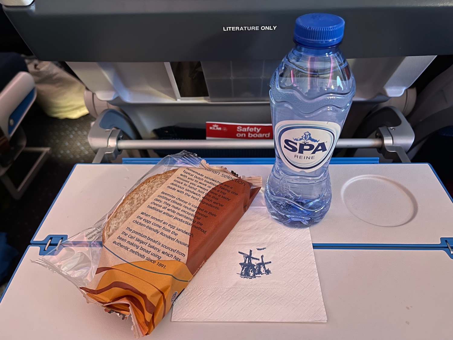 a sandwich and water bottle on a tray