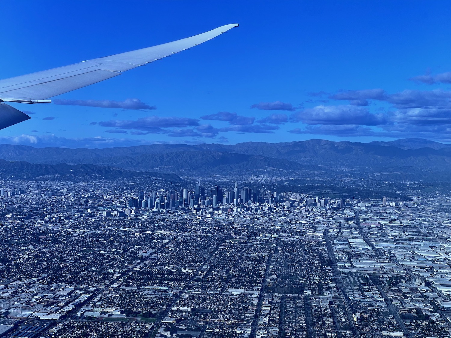 an airplane wing over a city