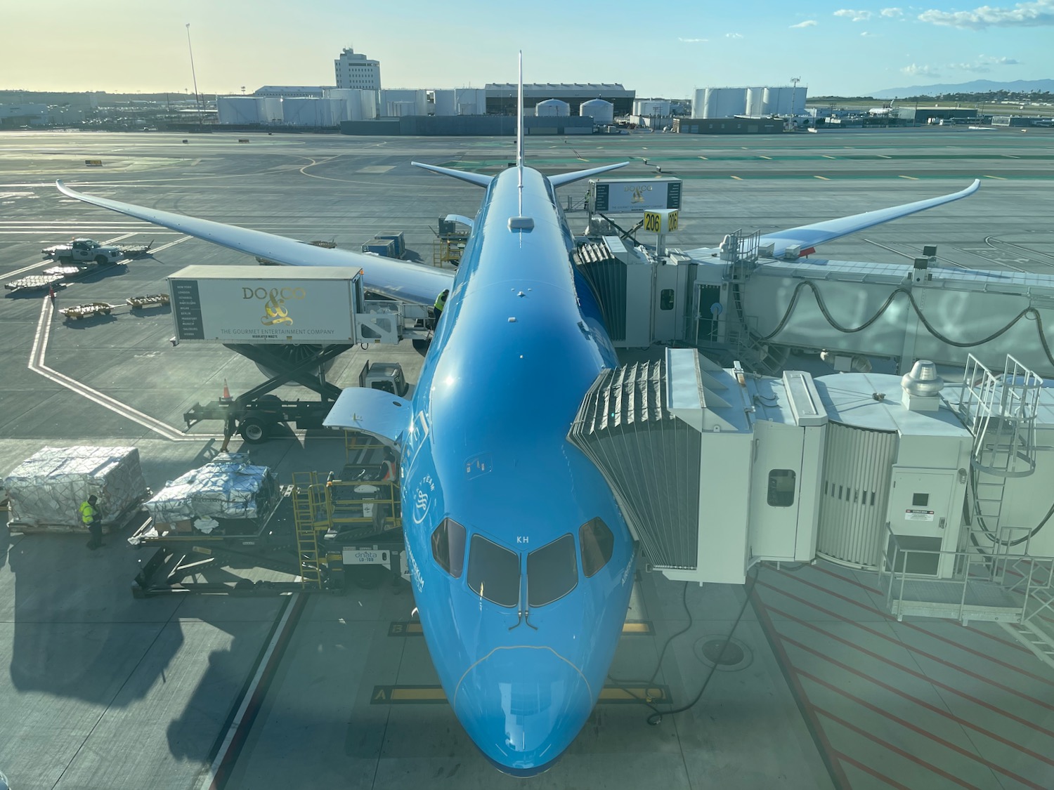 a blue airplane at an airport