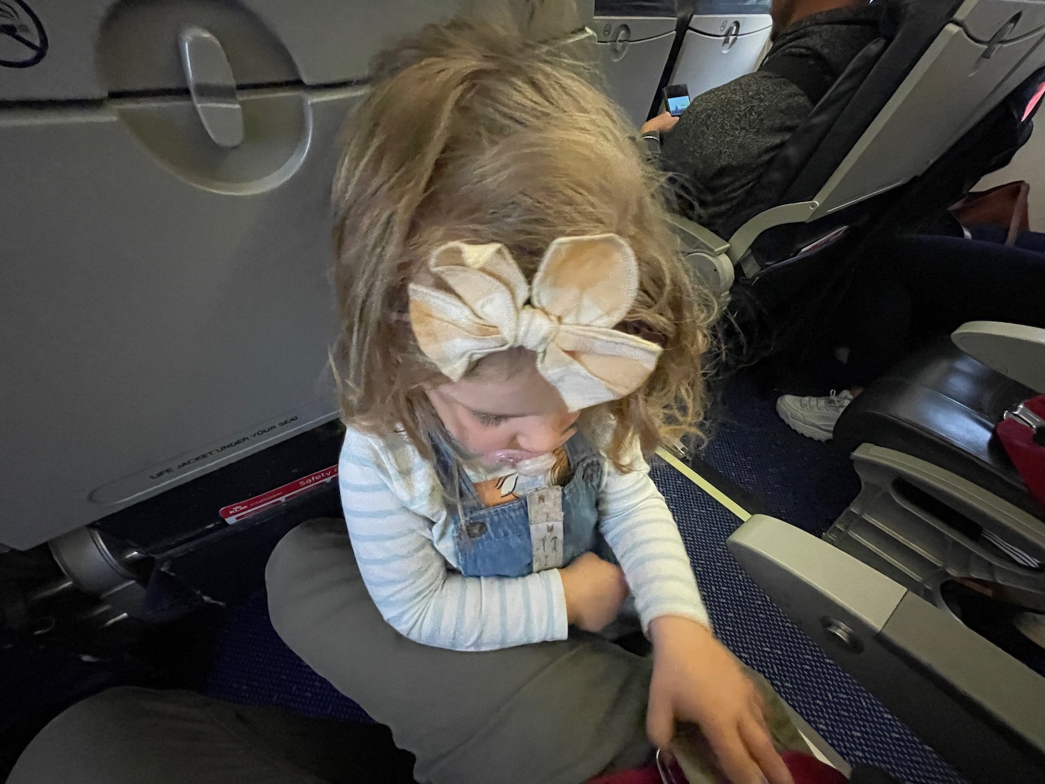 a girl sitting on an airplane