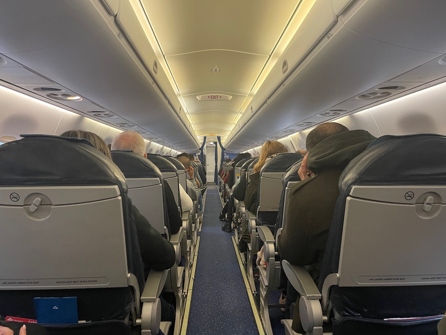 a group of people sitting in an airplane