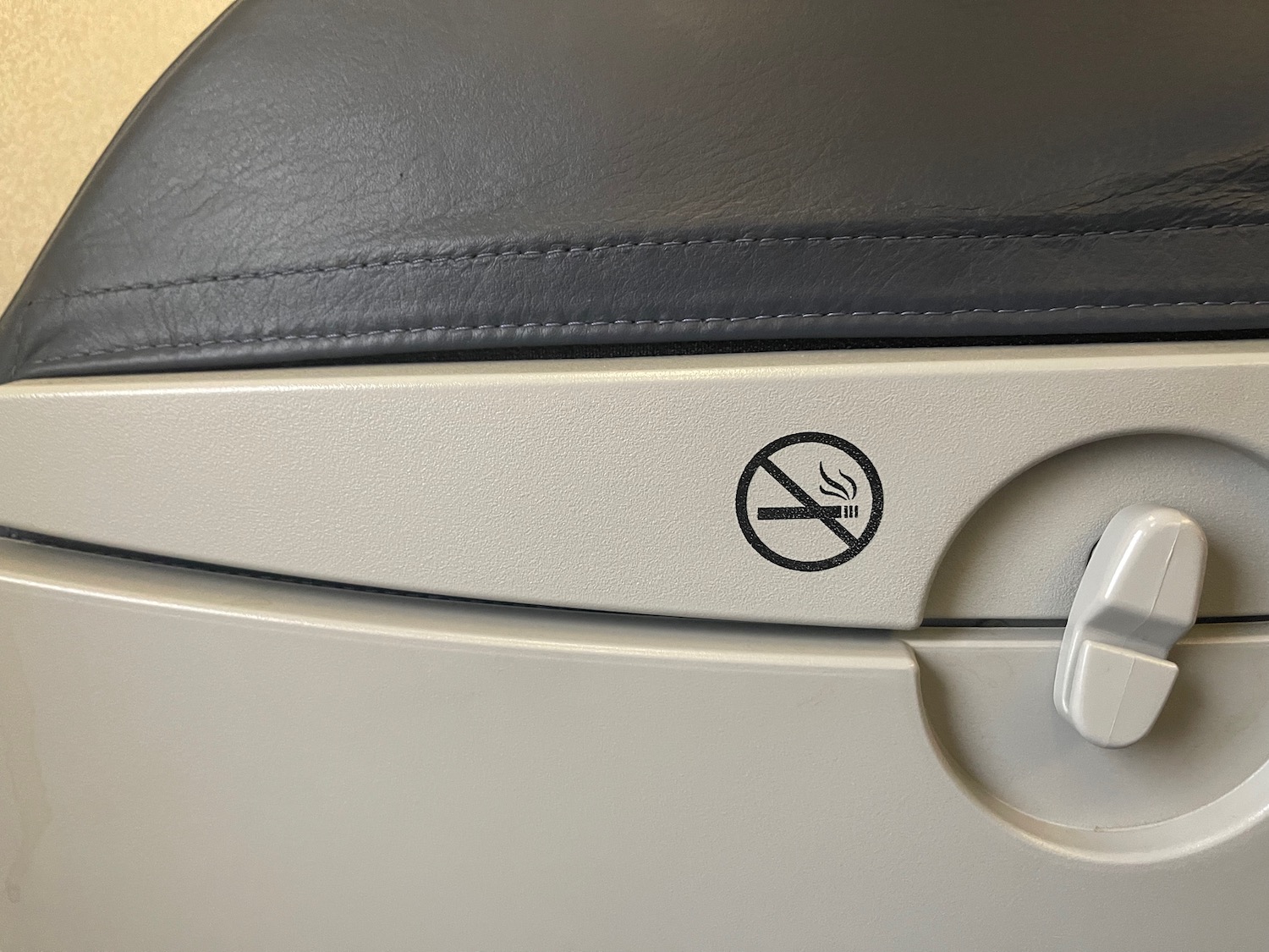 a no smoking sign on an airplane seat