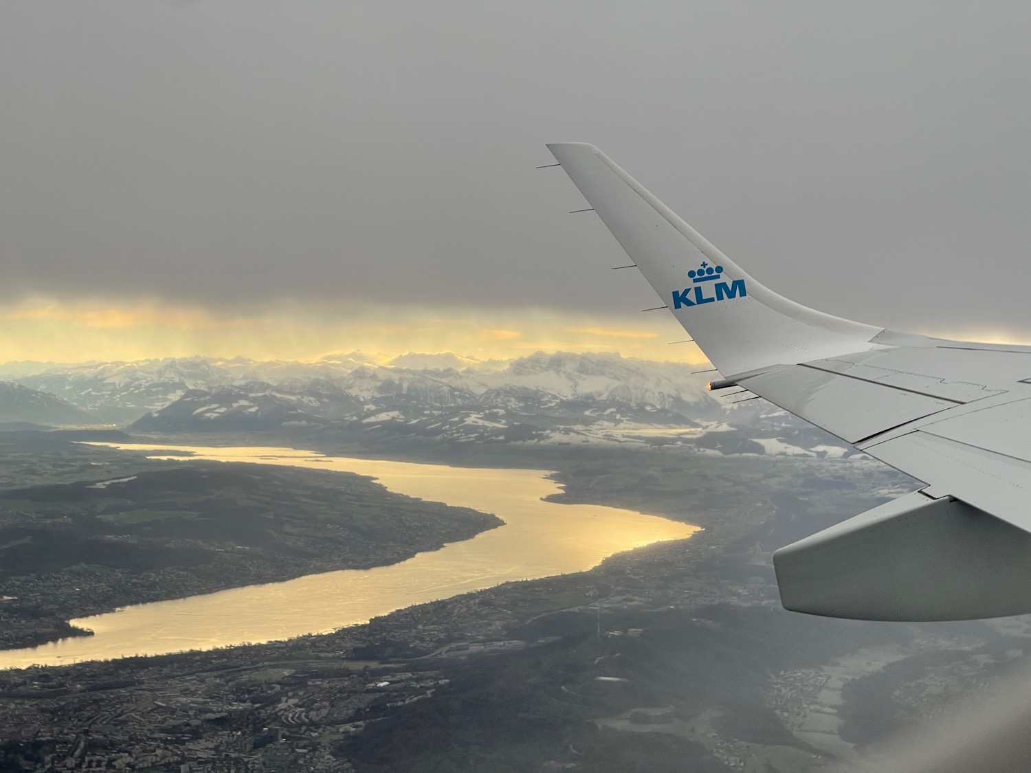 an airplane wing and a river in the sky