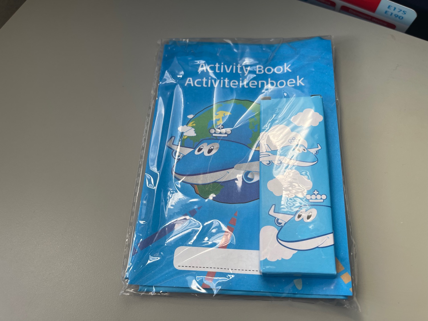 a blue activity book in plastic wrap