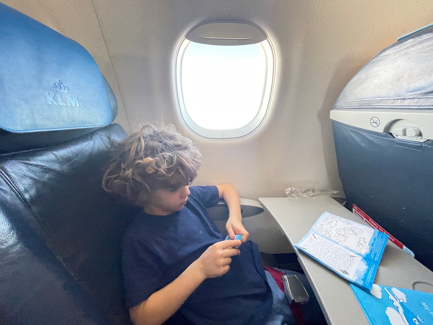 a boy sitting on an airplane