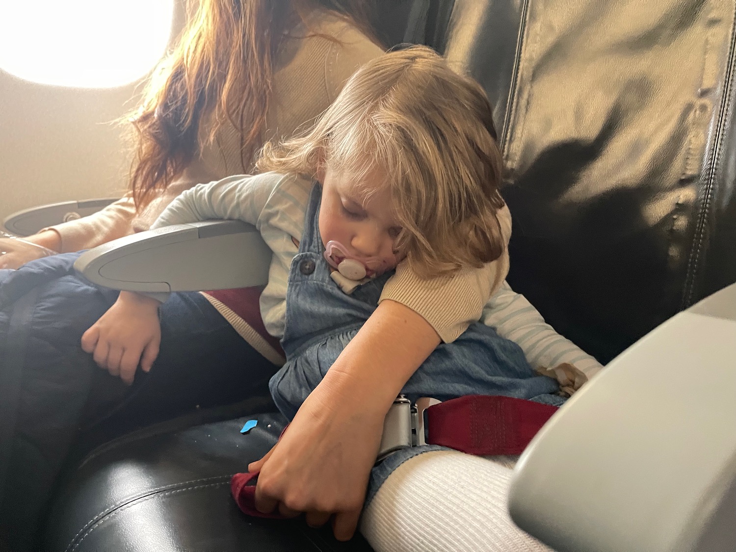 a child sleeping on a seat