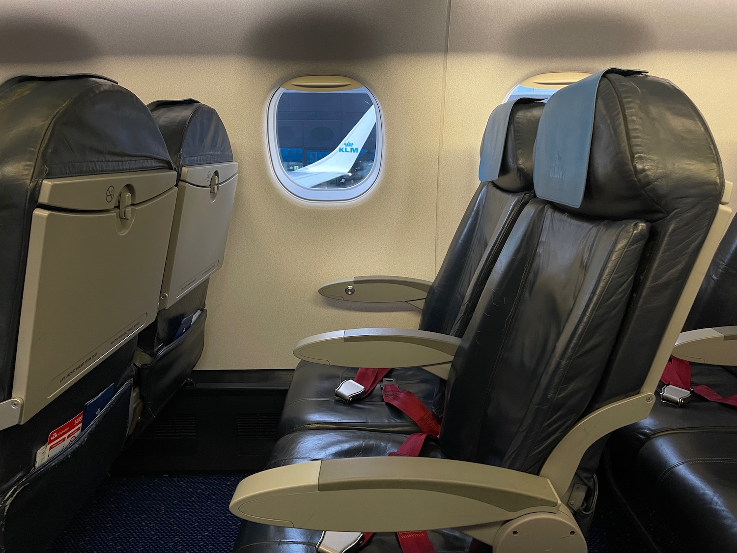 seats in an airplane with a seat belt