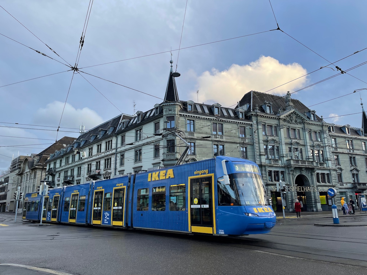 a blue train on a street