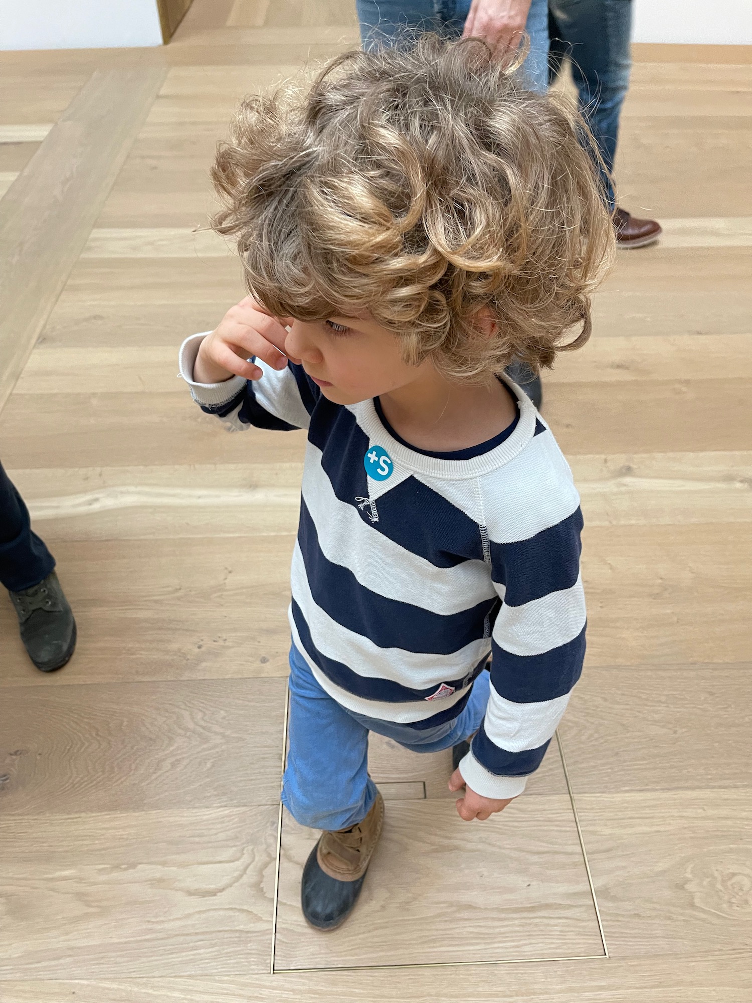 a child standing on a wood floor