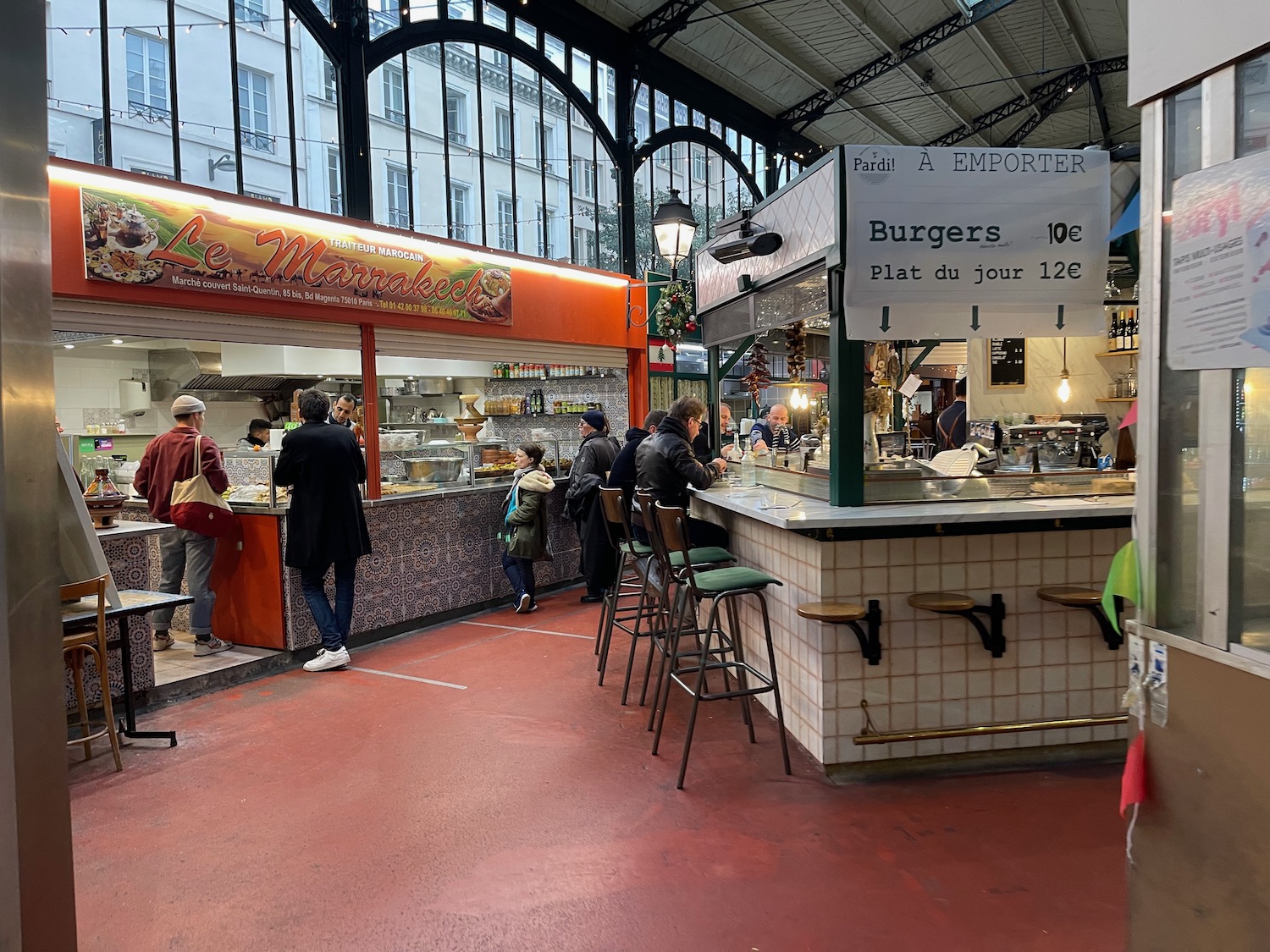 people standing at a counter in a market