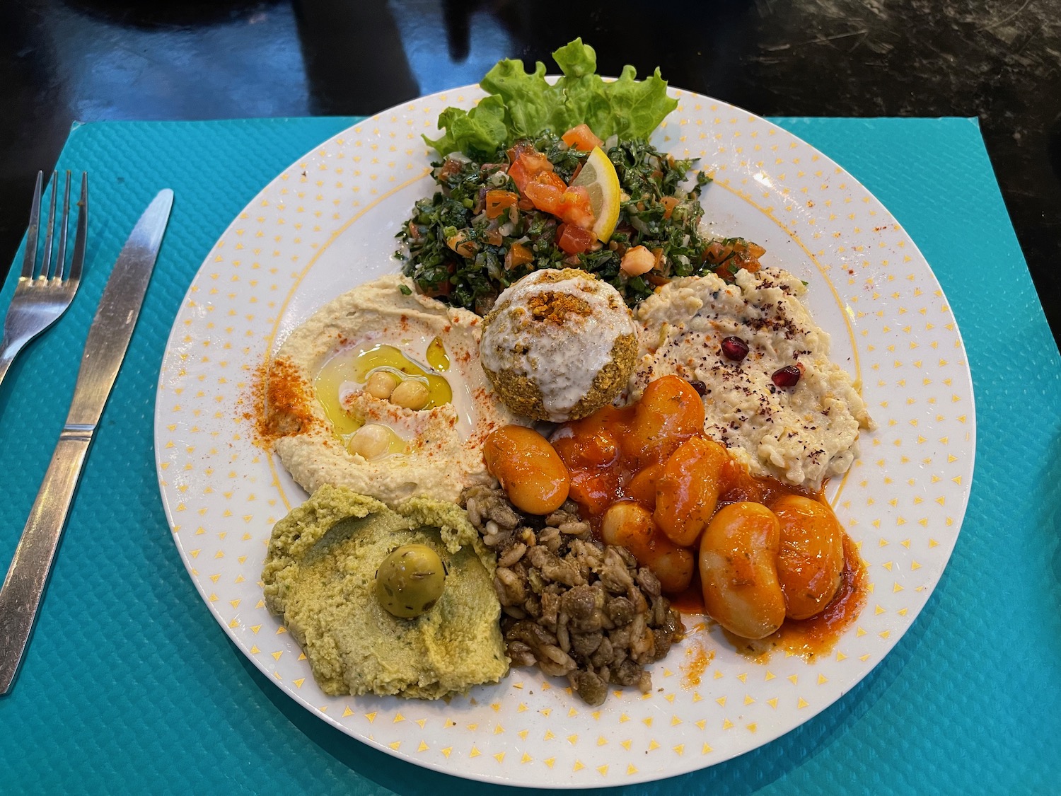 a plate of food on a blue place mat