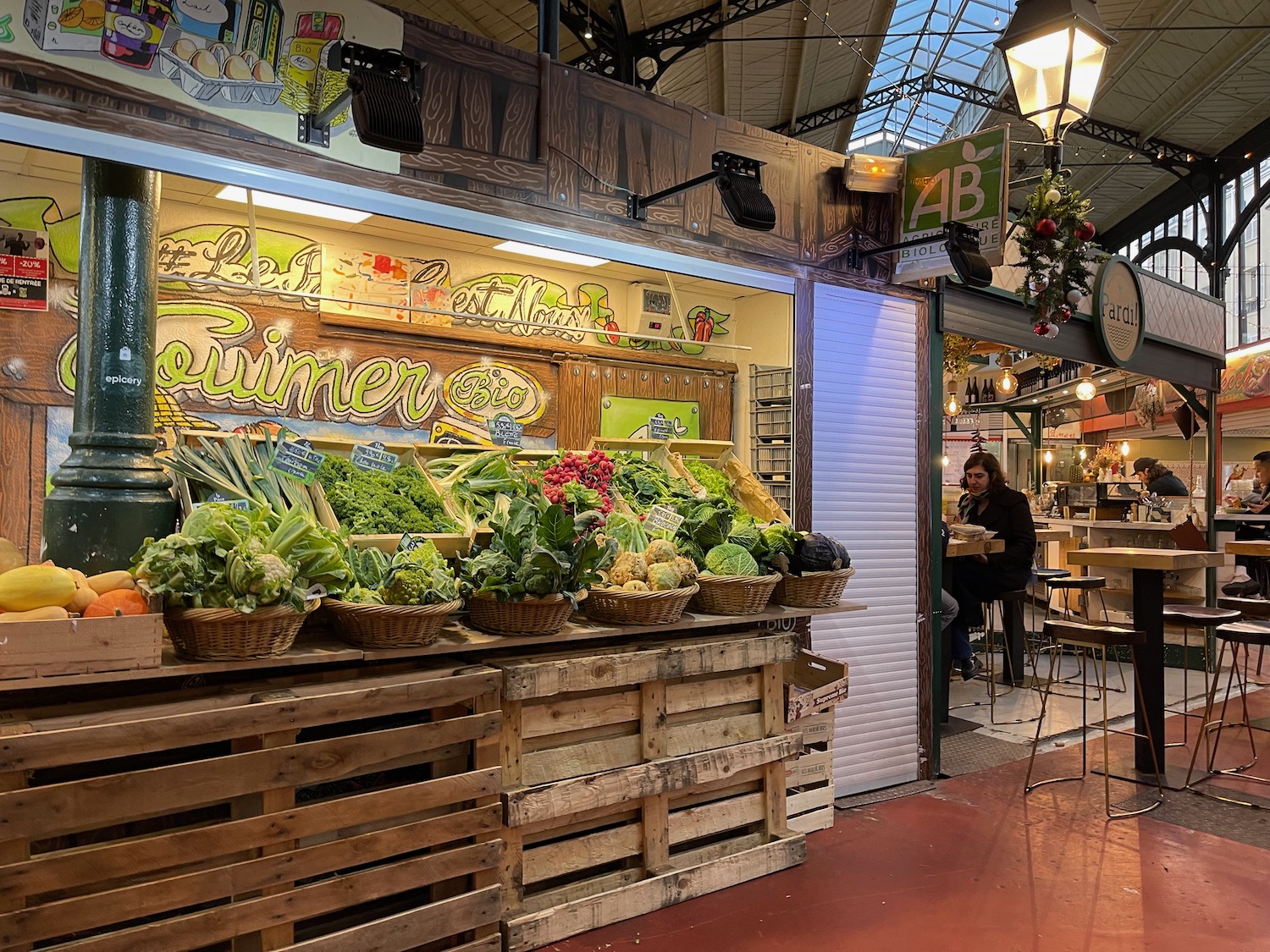 a food stand with vegetables and fruits