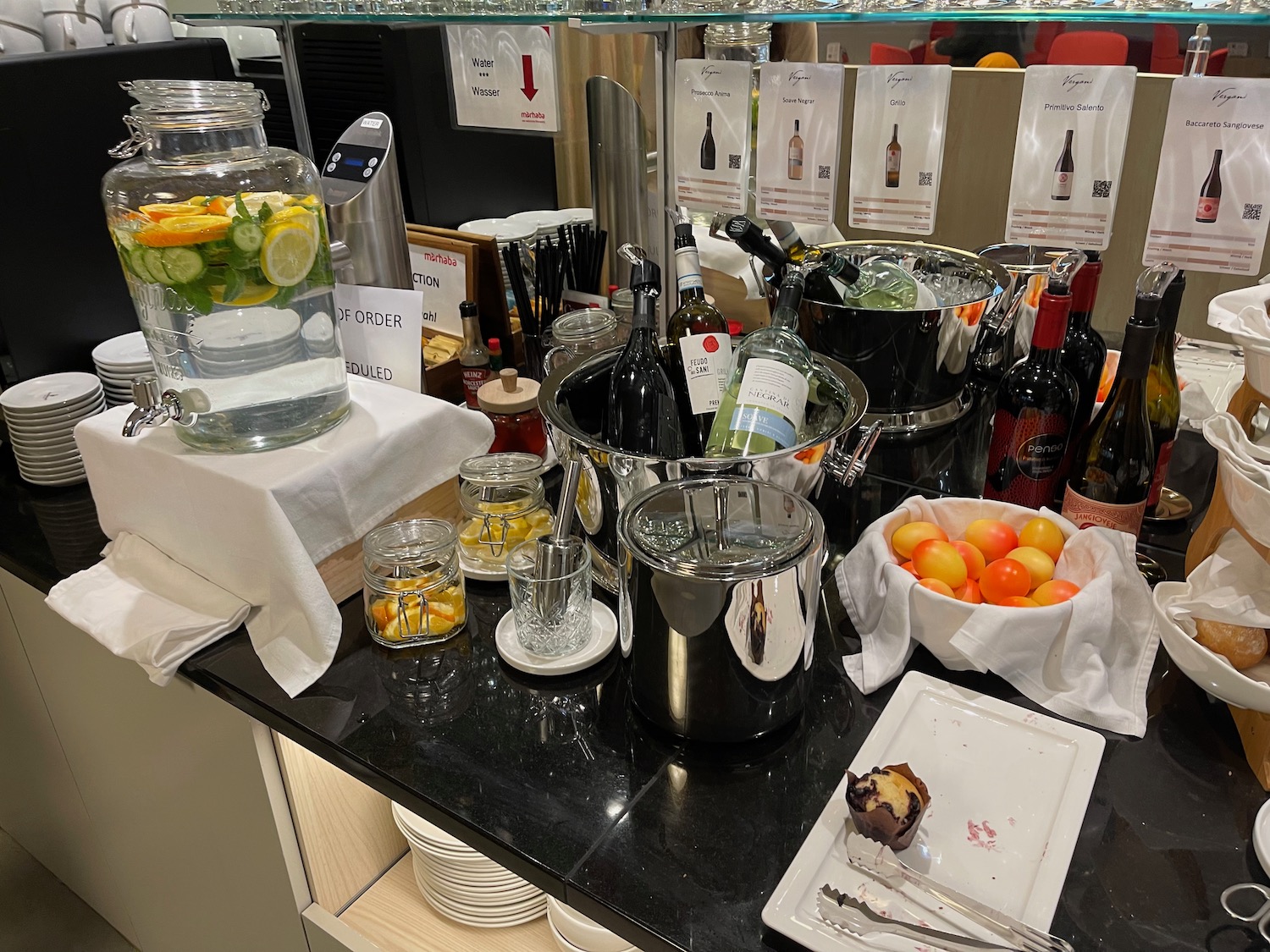 a counter with a variety of bottles and food