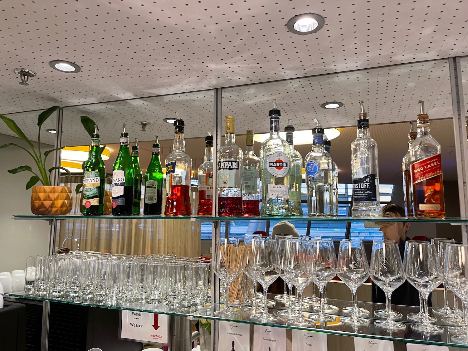 a shelf with bottles and glasses