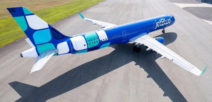 a blue and white airplane on a runway